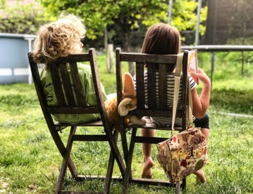 two children sitting on chairs