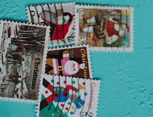 Several vintage christmas postage stamps on blue background