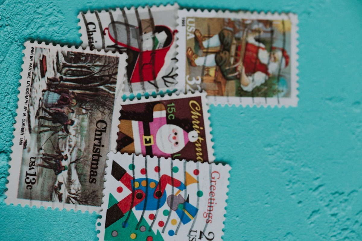 Several vintage christmas postage stamps on blue background